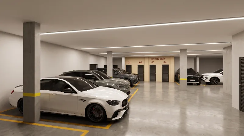 Garagem coberta do Residencial AltaVille com as portas numeradas dos depósitos privativos Hobby Box ao fundo